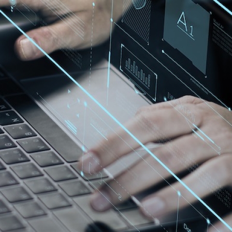 Hands over a laptop keyboard