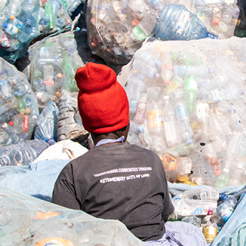 A person sorting plastic waste © James Wakibia
