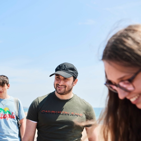 Students walking along the beach at Southsea in summer