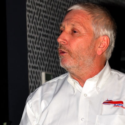 Alan Priddy stood giving a talk wearing a shirt