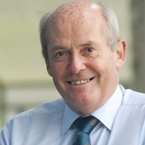 Headshot of Sir William Wakeham smiling to camera