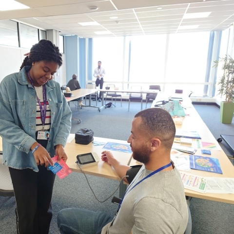 Student pharmacist taking a man's blood pressure