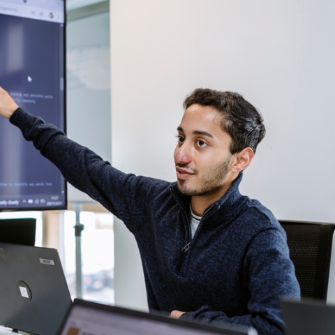 Student showing HTML on a projected computer