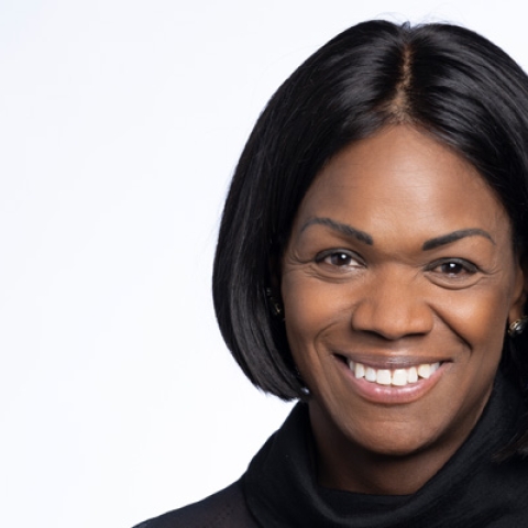 Headshot of Dame Vivian Hunt smiling to camera