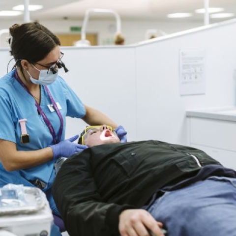 Dental student learning practical skills in Dental Clinic