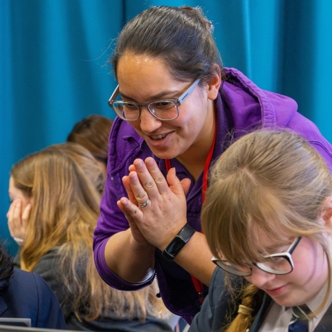 Image of University lecturer talking to pupils from Kings Academy Bay House at a digital skills workshop