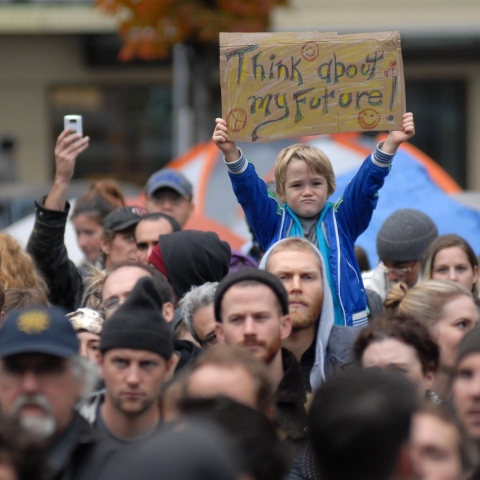 Young child holding sign at a climate change protest