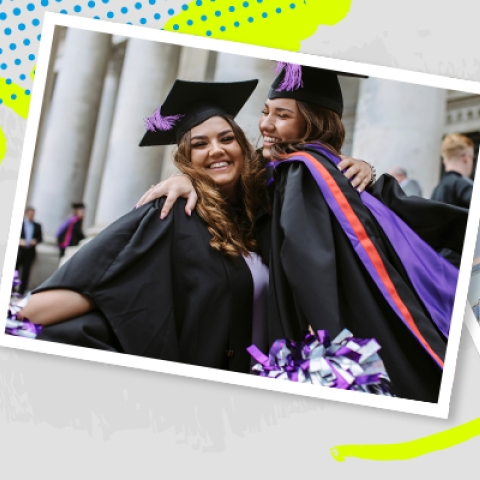 Two female students hugging and smiling at university graduation