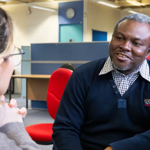Two people sitting and talking
