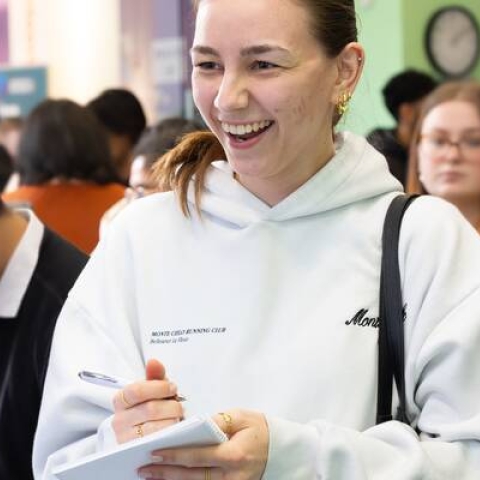 A student at a careers fair speaking to a member of staff