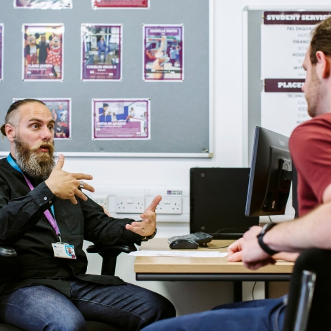 Two people sitting and talking