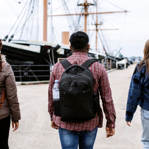 Students walk toward historical ship