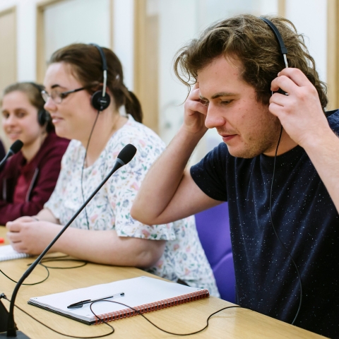 Male translator in speaking into microphone