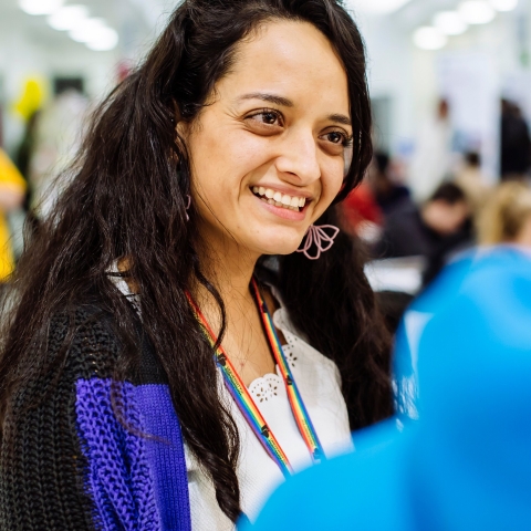 Female employee wearing rainbow lanyard