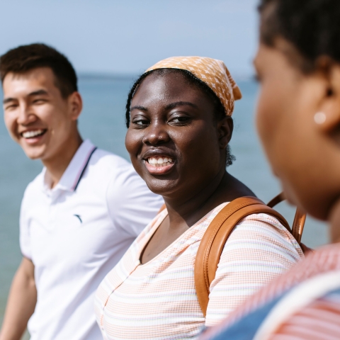 Three people walking and chatting.