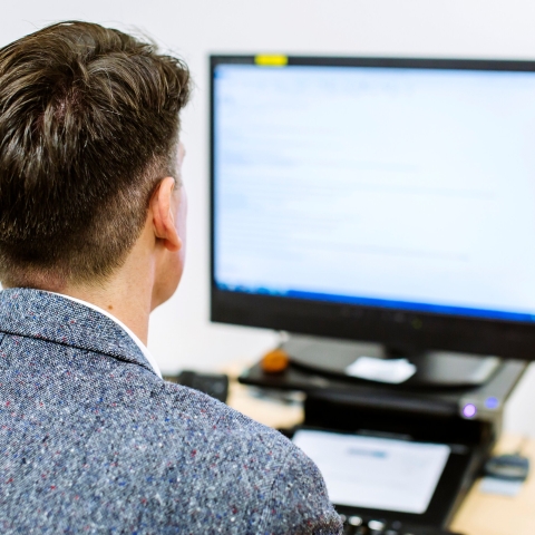 A man looking at a computer screen