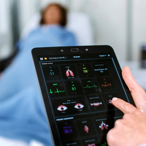 doctor studying vitals on tablet computer