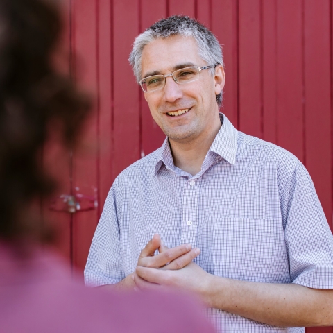 Dr Simon Kolstoe in conversation with a person.