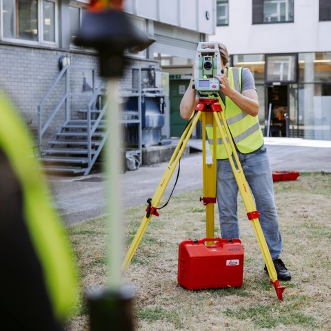 Student conducts measurements using landscape mapping device outside Technology Facilities