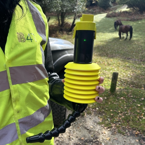 Someone holding a prototype of a new sensor to detect greenhouse gases in water 
