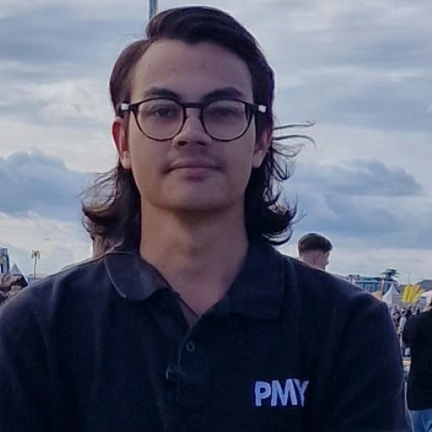 James Edge looking to camera wearing black PMY Group polo t-shirt at Victorious Festival