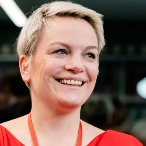 Jo de Serrano smiling and laughing in headshot image