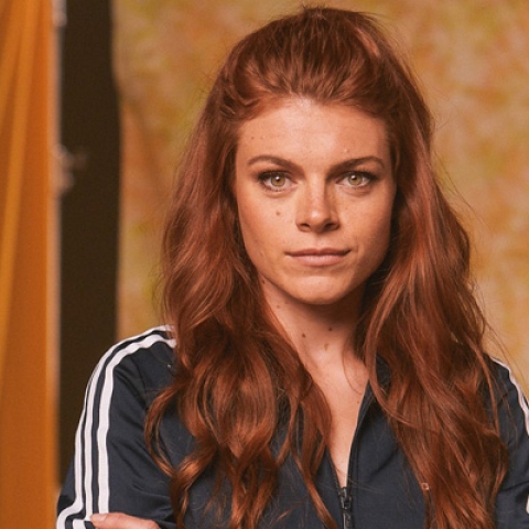 Lauren Steadman looking to camera wearing blue with white striped sports jacket