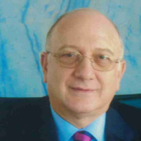 Headshot of Michael Erotokritos wearing suit and tie