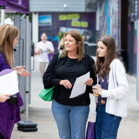 Student ambassador helping family with questions  - Open Day 2023