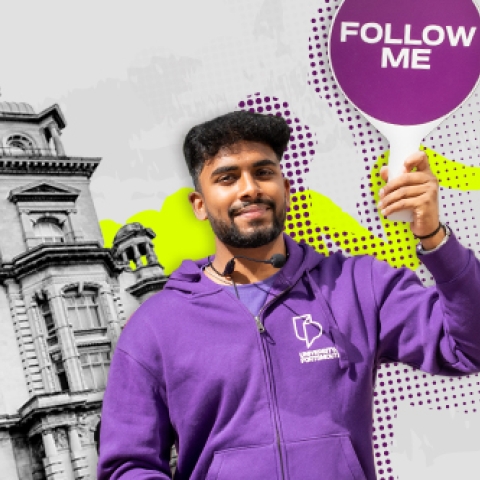 Student ambassador holding "Follow me" sign