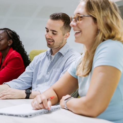 Colleagues discussing ideas in a meeting room