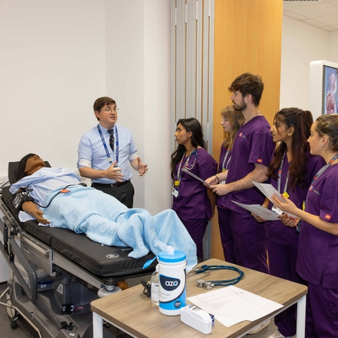 Medical Degree students watching a demonstration in mock hospital ward