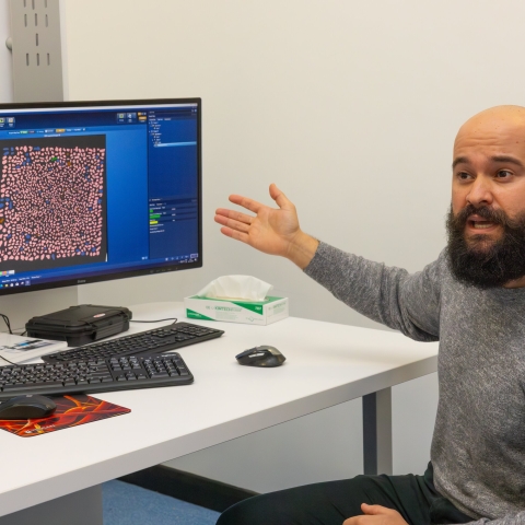Researcher Dr Hugo Moreira gesturing at an image on a computer screen