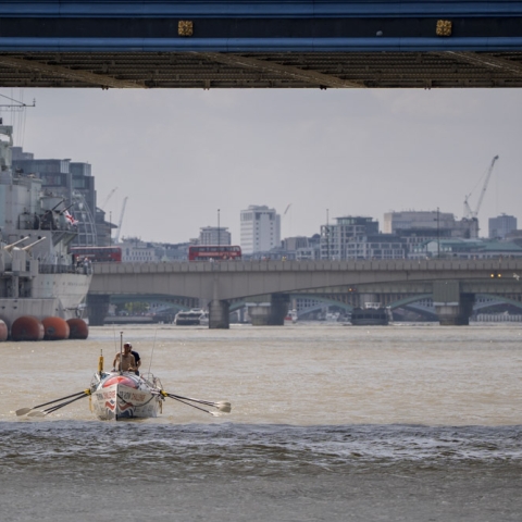Rowing boat underneath Tower Bridge, London 