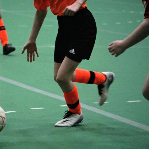 female football player kicking ball