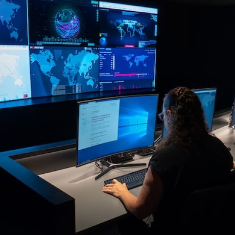 Students sitting in front of surveillance screens