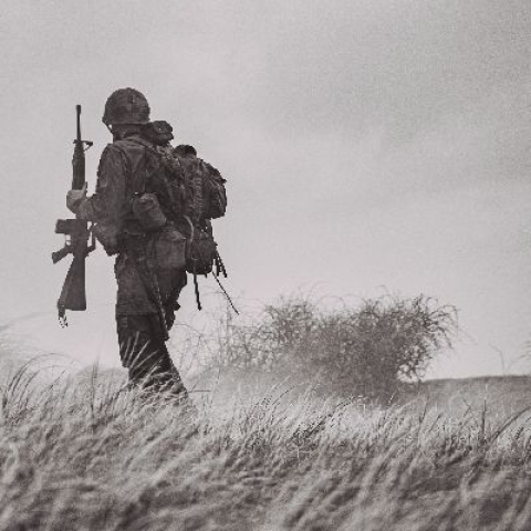 Military fighter holding riffle -  Photo by Eduard Delputte on Unsplash