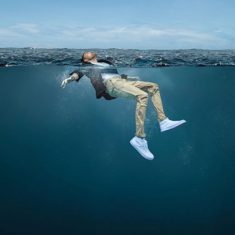 man floating in water for Float to Live campaign photo