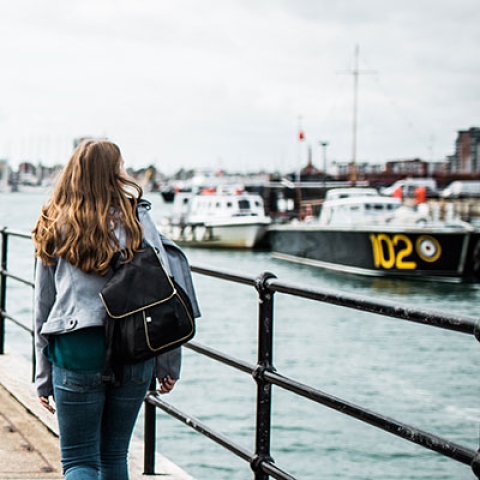 Students walk toward historical ship