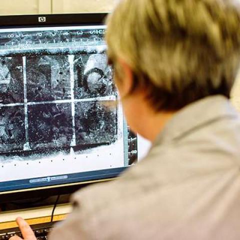 Student looking at computer screen showing fingerprints