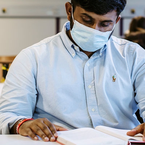 Man in mask reading under COVID-19 lockdown