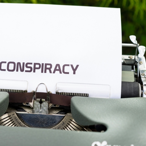 typewrite with the word conspiracy typed onto a piece of paper.