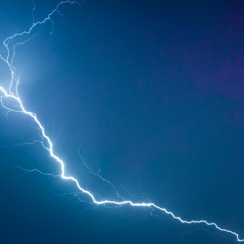 A lightning strike on a dark blue sky