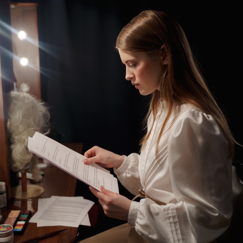 A theatre actor reading a script