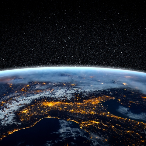 Close up of the earth from space at night with street lights visible