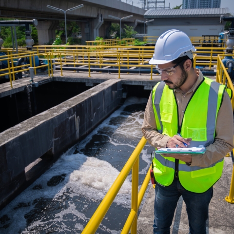 Engineer take water from  wastewater treatment pond to check the quality of the water. After going through the wastewater treatment process.