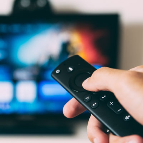 Person using TV remote
