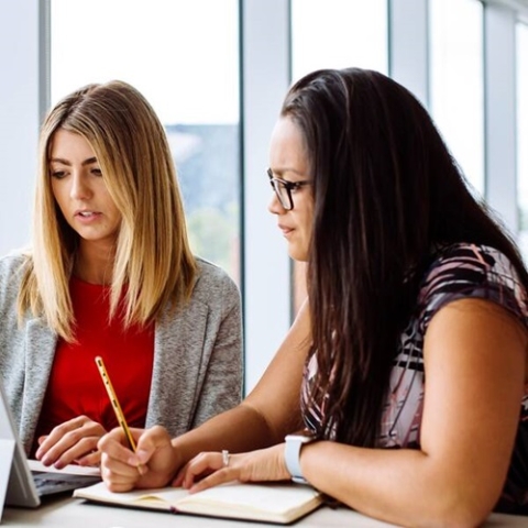 two women looking at a screen
