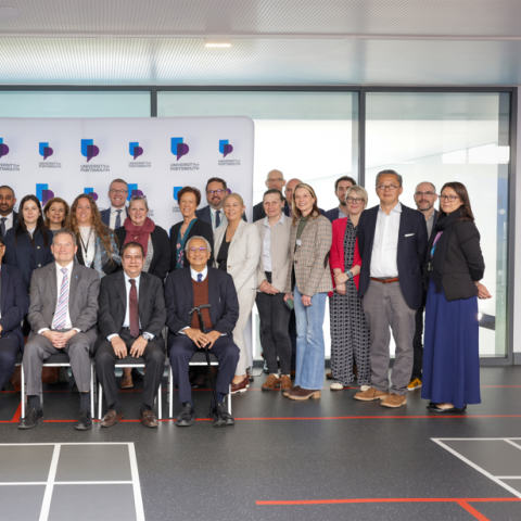 Portsmouth and Malaysian university teams in group photo during signing event