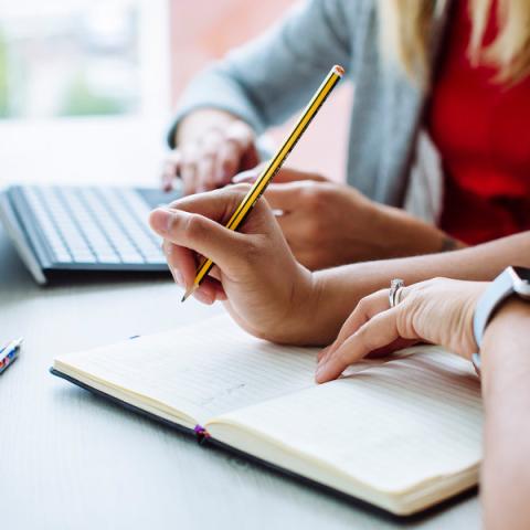 female lawyer holding a pencil, making notes